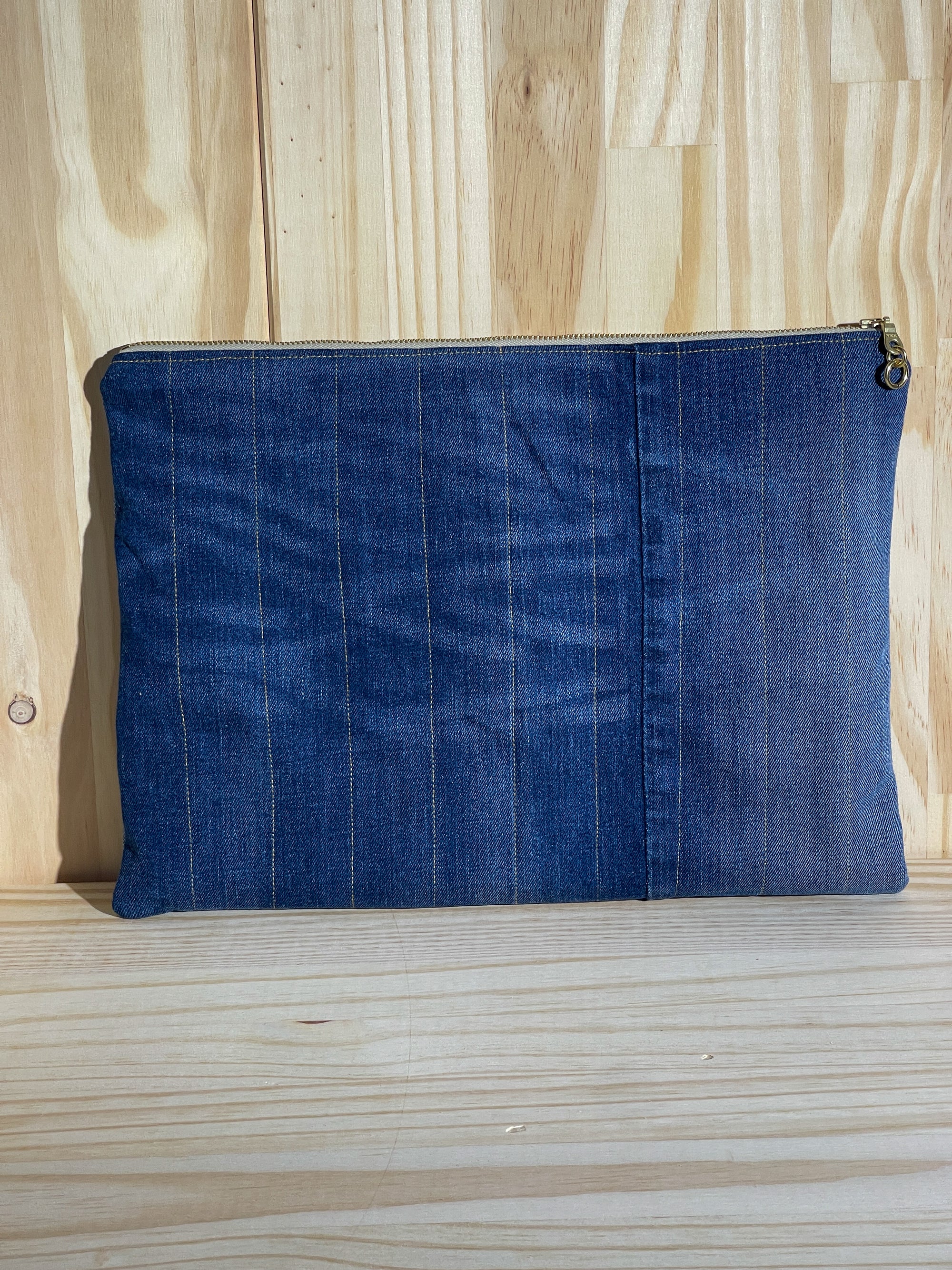Blue handmade eco up-cycled denim laptop sleeve back on a wooden surface