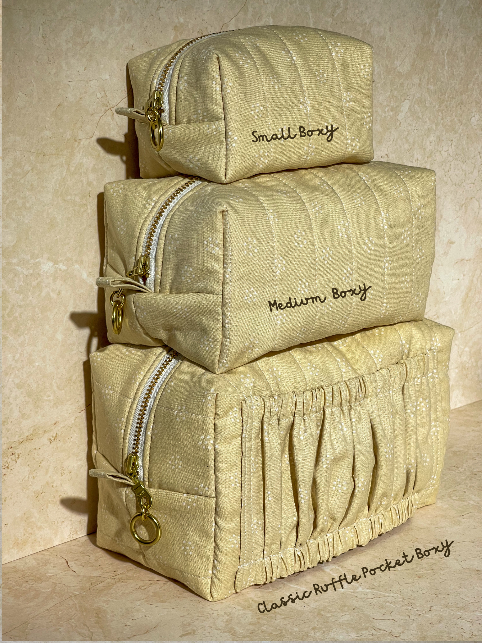 Stack of beige Lovinglog sustainable pouch bags with floral pattern on a beige background