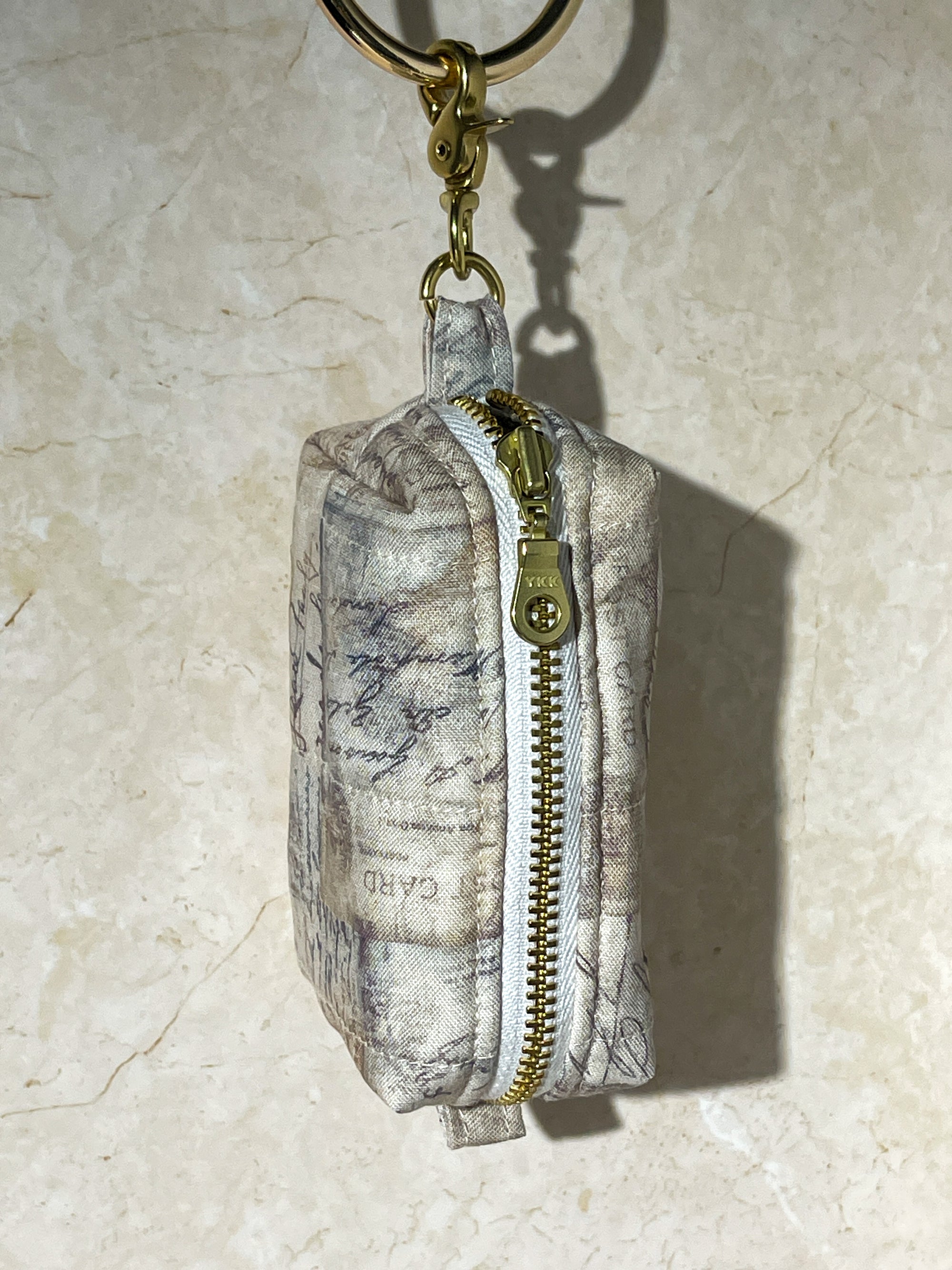 Handmade fabric map design pouch on a beige marble background