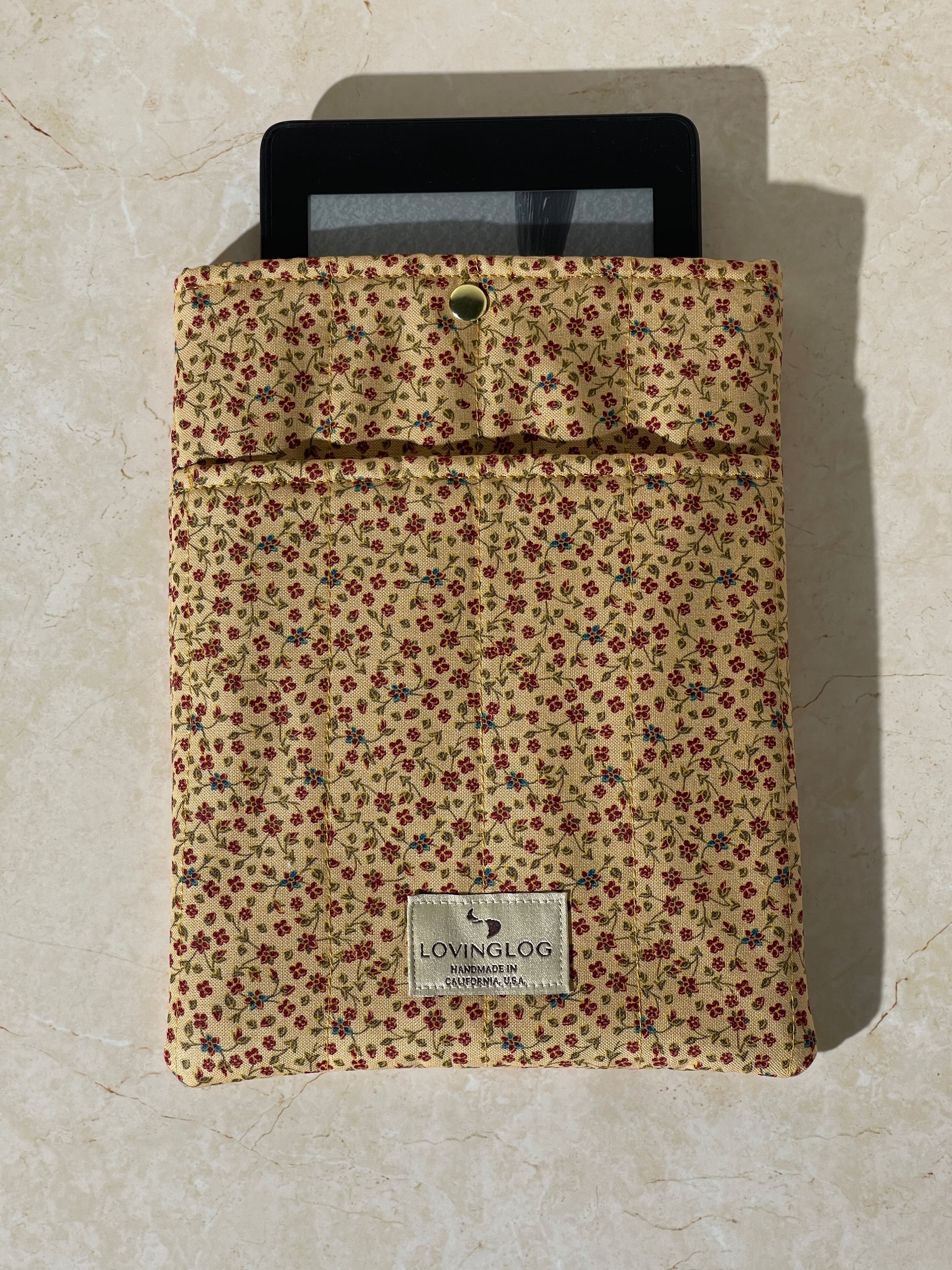 Lovinglog Sustainable floral pattern cotton Books, Kindle Sleeve on a beige surface