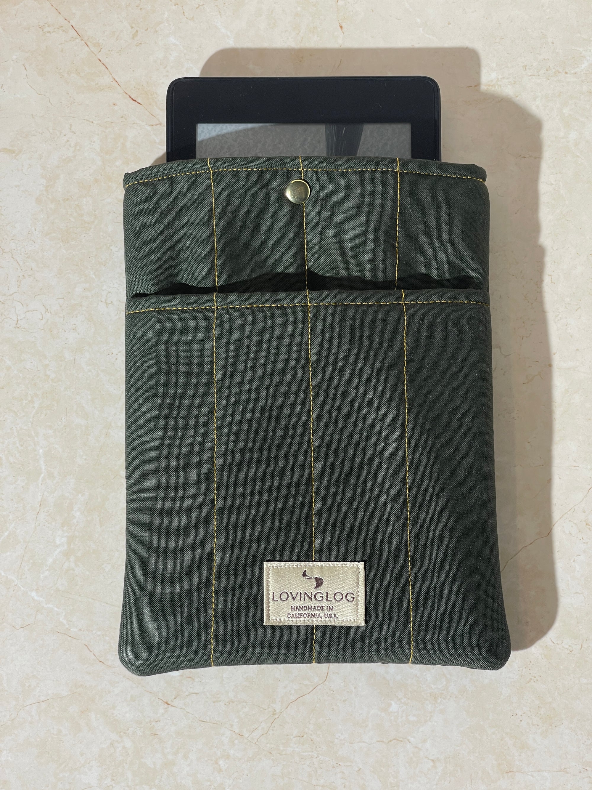 Lovinglog Sustainable Green cotton Books, Kindle Sleeve on a beige surface
