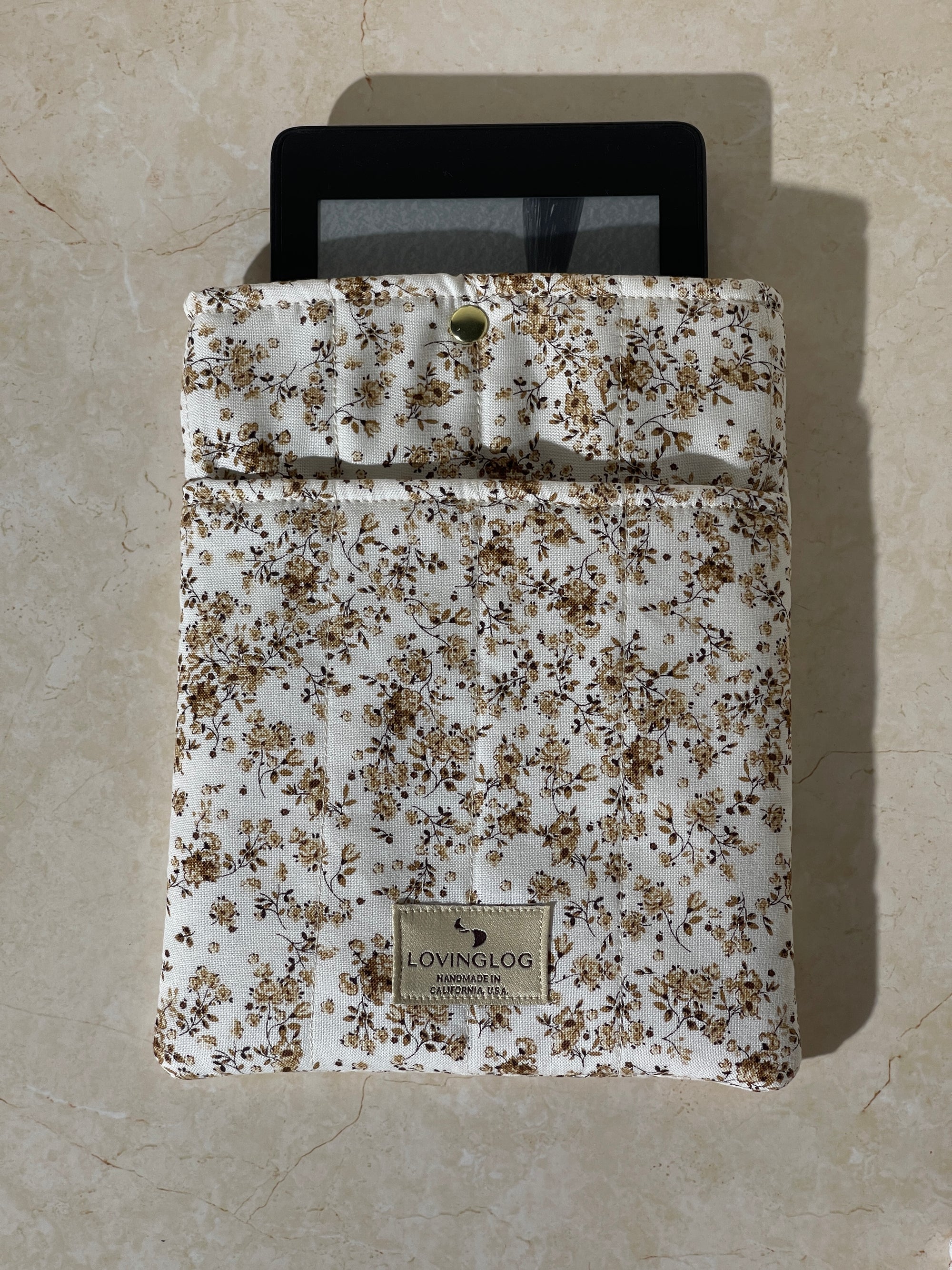 Lovinglog Sustainable white floral pattern cotton Books, Kindle Sleeve on a beige surface