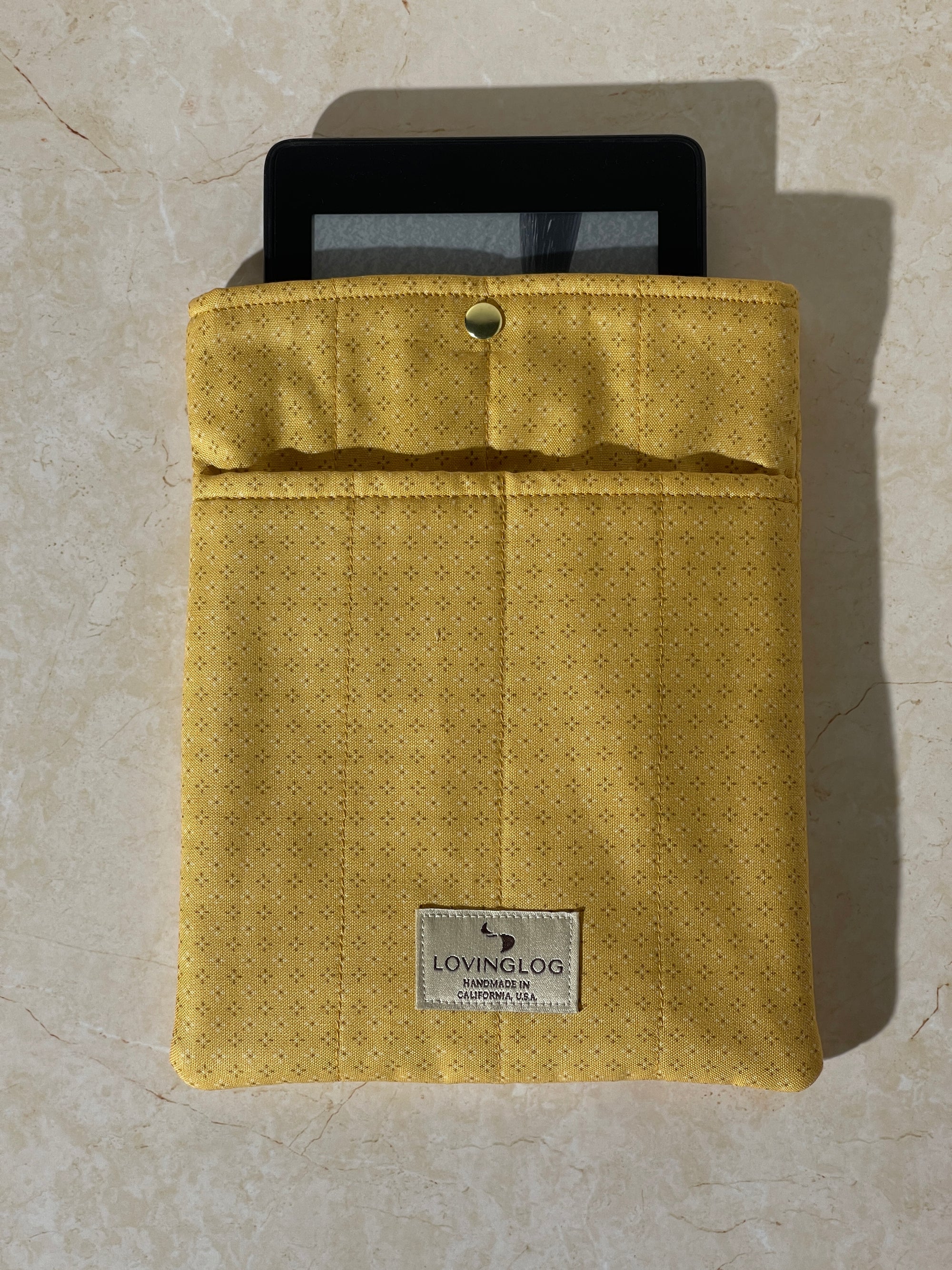 Lovinglog Sustainable Yellow cotton Books, Kindle Sleeve on a beige surface
